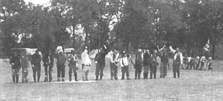Men lined up at edge of battlefield